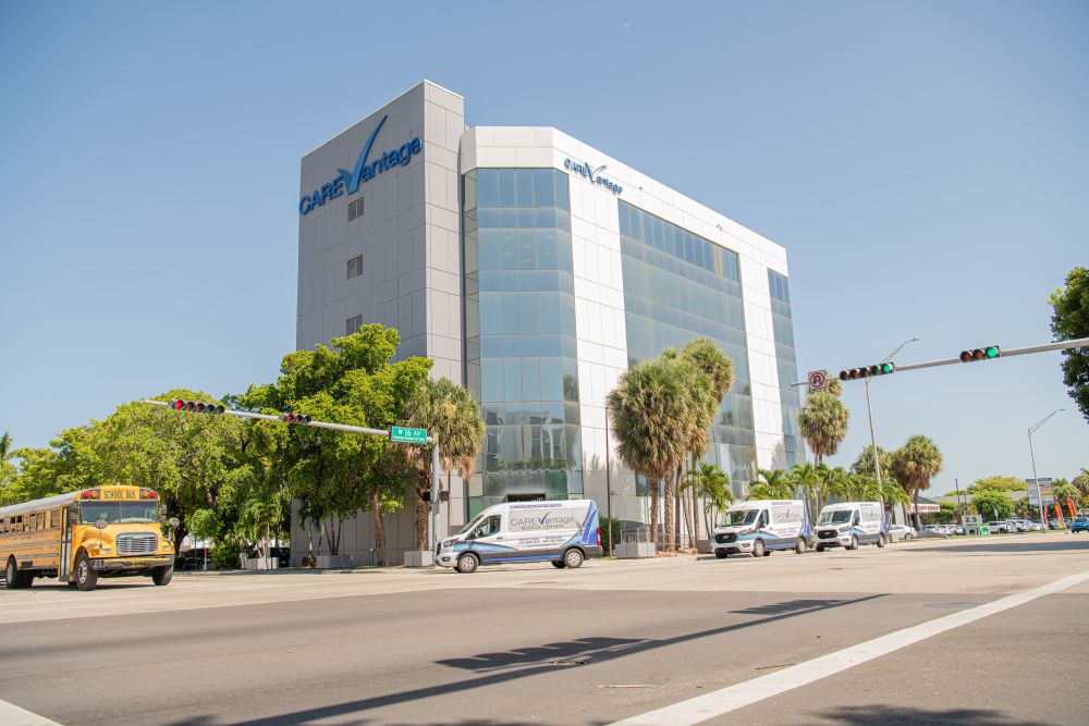Exterior of the CareVantage building with parked vehicles